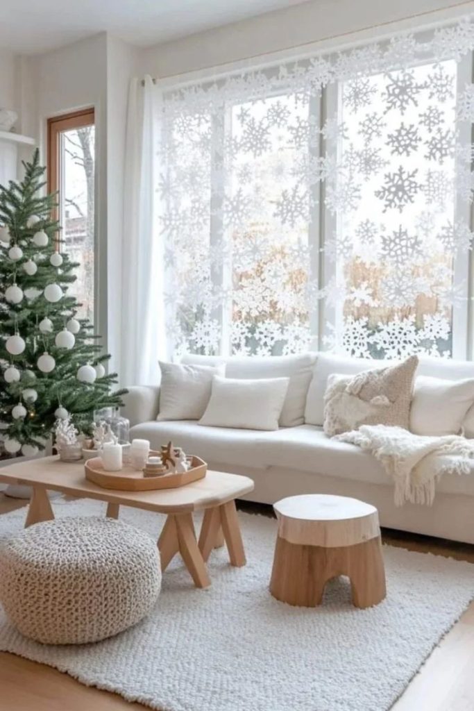 White snowflake window decorations with glowing fairy lights.